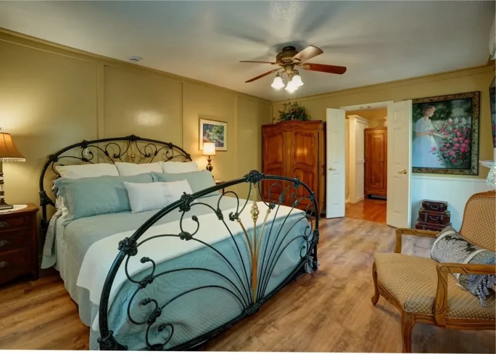 A wide shot of the same bedroom, showing a sitting area with a couch.